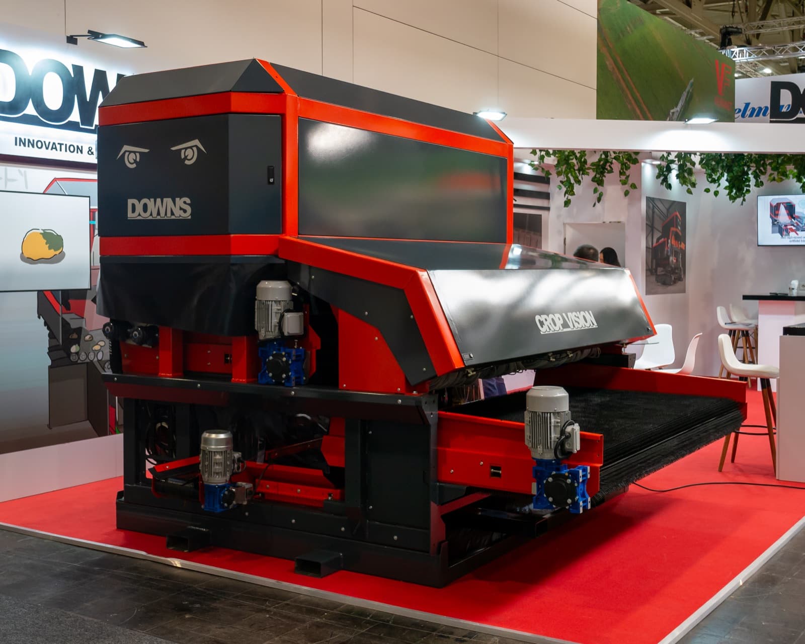 Camera-based potato grading and sorting machine with a wide roller infeed, shown at a farm machinery trade fair