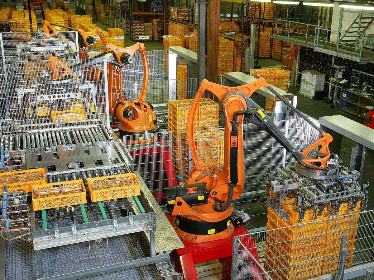 Industrial robots palletising crates of bread